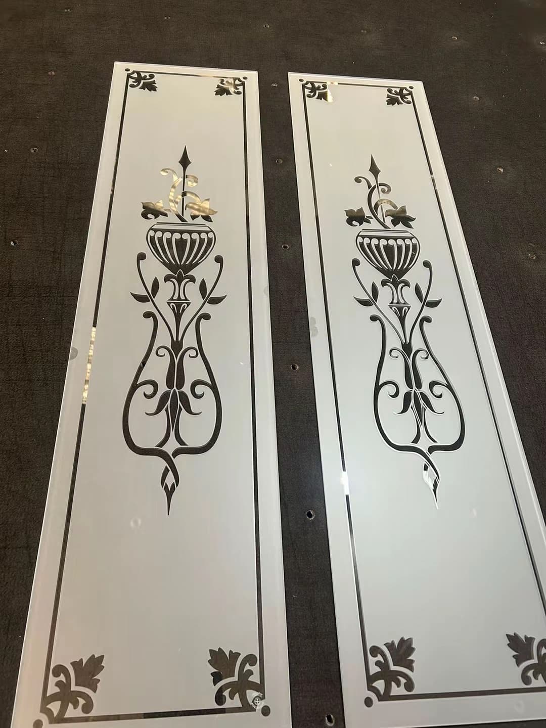A pair of tall door panels with urn and floral motifs inside a fine border
