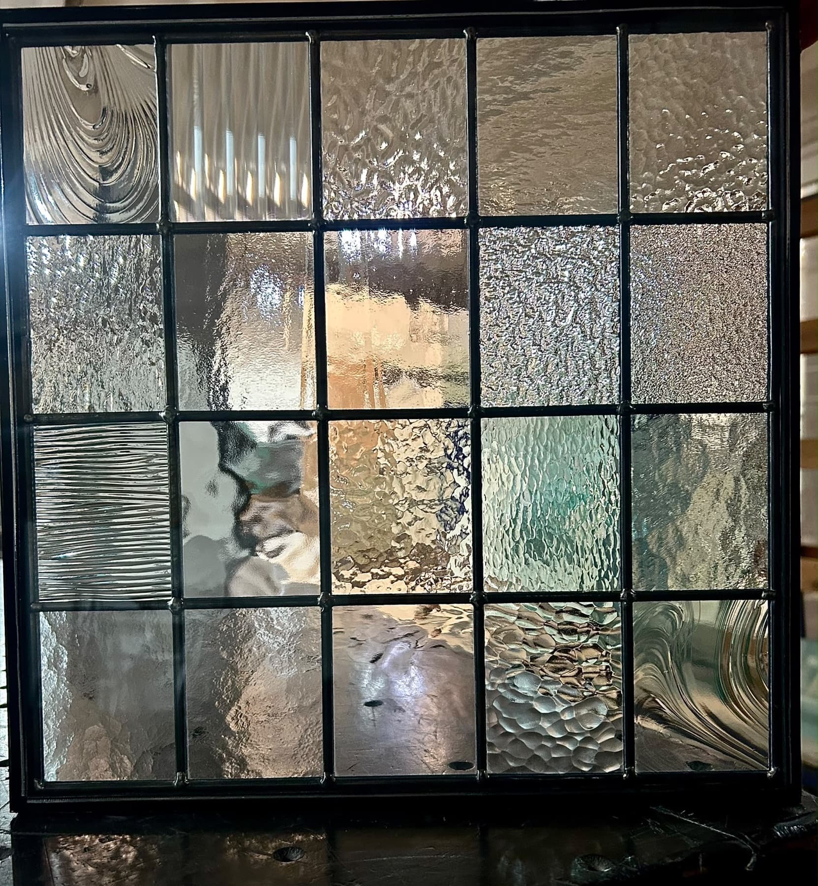 Grid of twenty clear glass textures in a leaded frame